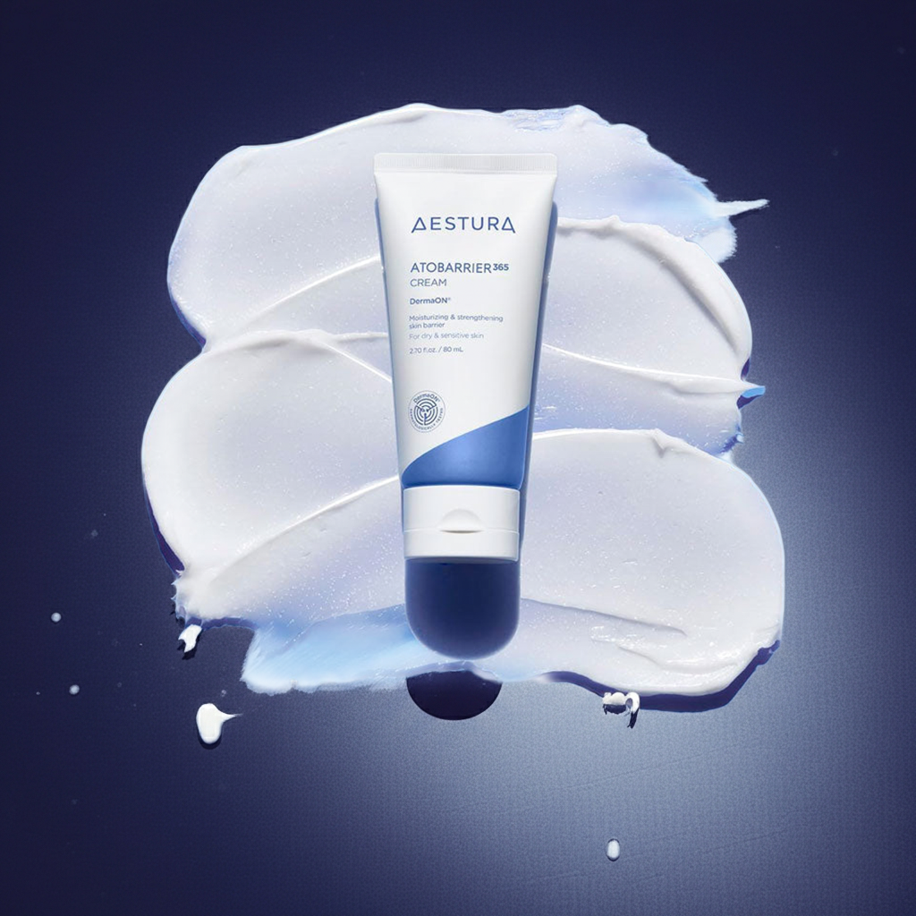 Aestura Atobarrier cream tube on a blue background with cream swatches.