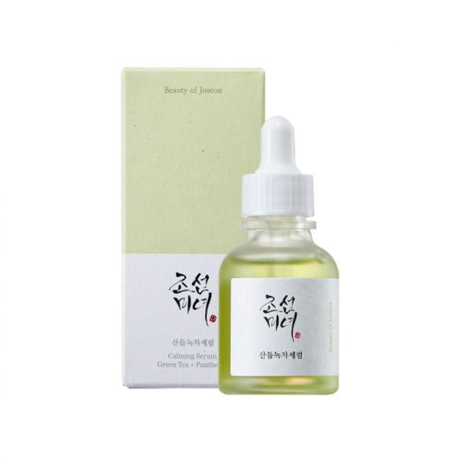 Skincare serum bottle with dropper and packaging on a white background