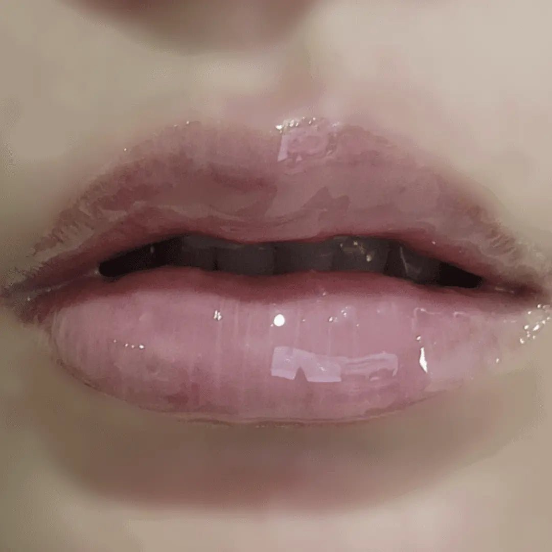 Close-up of glossy lips with a neutral background