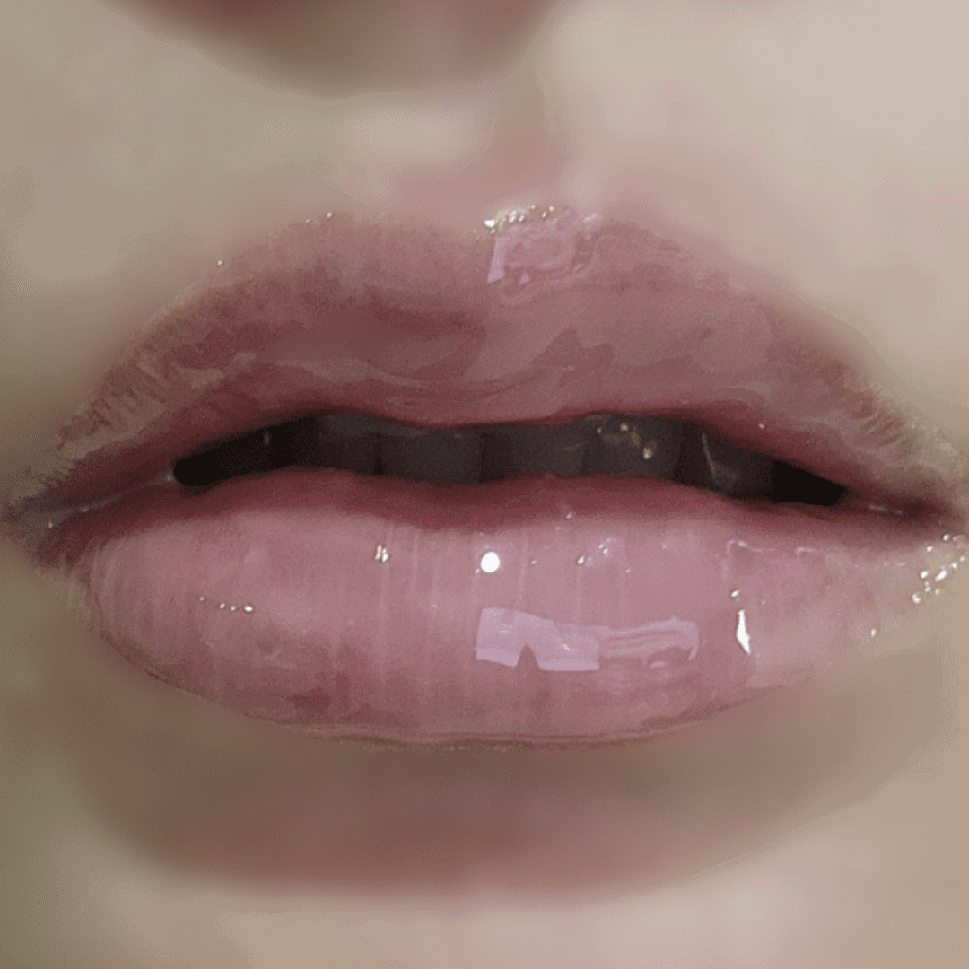 Close-up of glossy pink lips with a blurred background