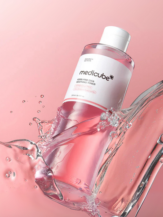 Medicube PDRN Pink Cica Sooting Toner with water splash on a pink background