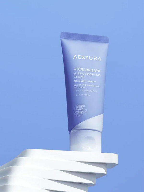 Aestura Atomerrier BB Hydro Soothing Cream tube on a white base with a blue background