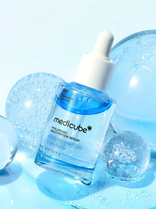 Medicube hyaluronic Multi Peptide serum bottle with dropper on a blue background