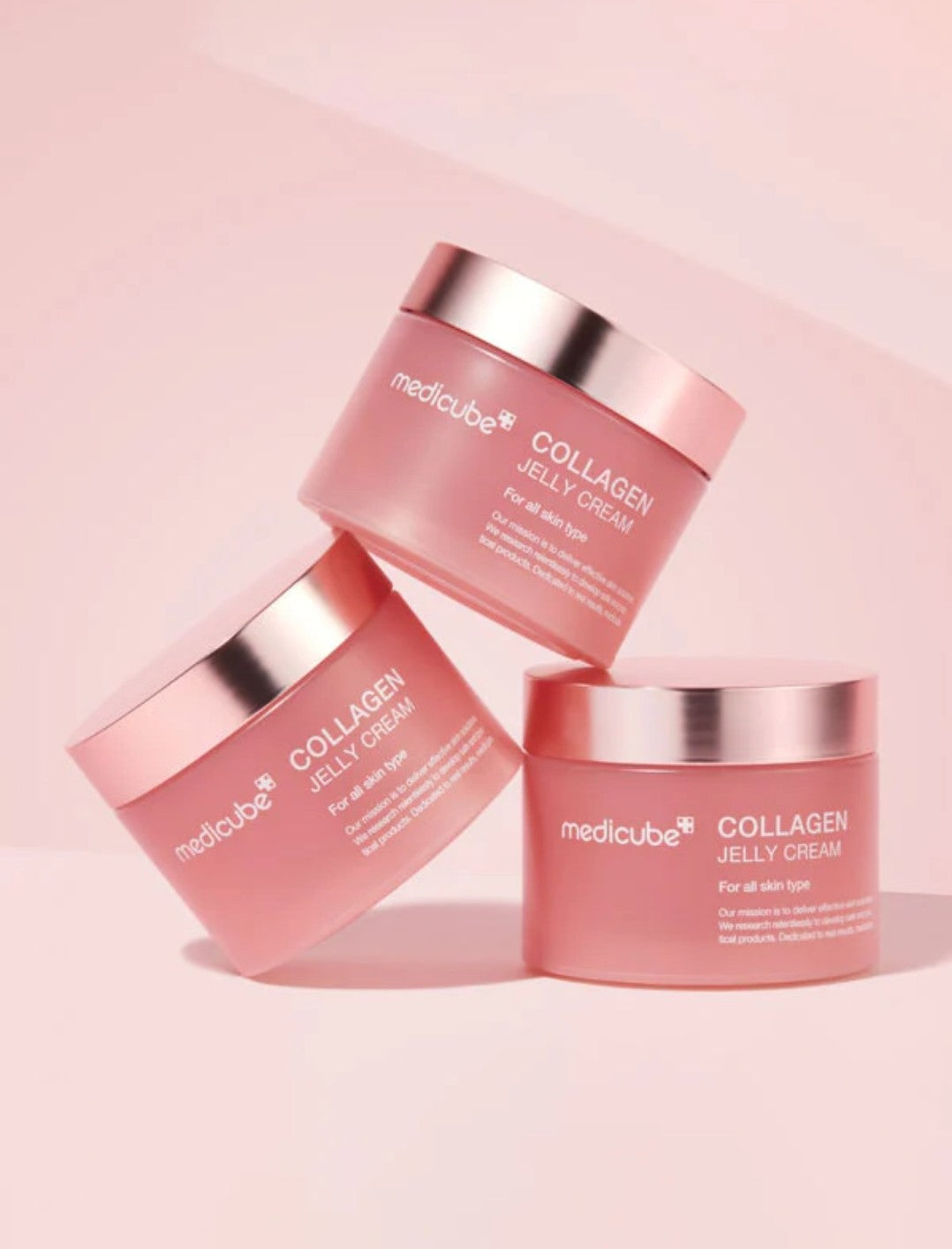 Three jars of Medicube Collagen Jelly Cream on a pink background